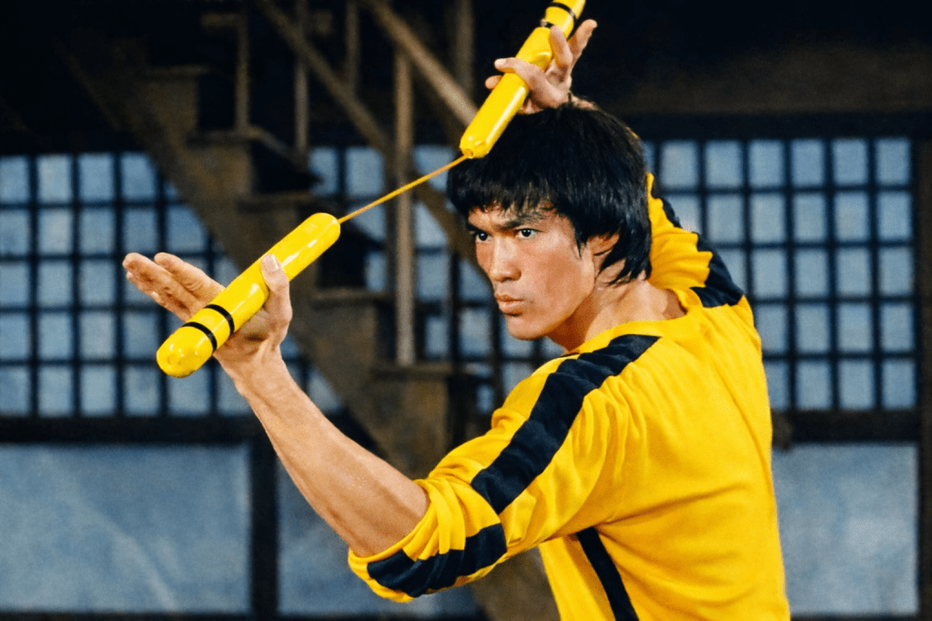 Bruce Lee in his iconic black-and-yellow jumpsuit from Game of Death.